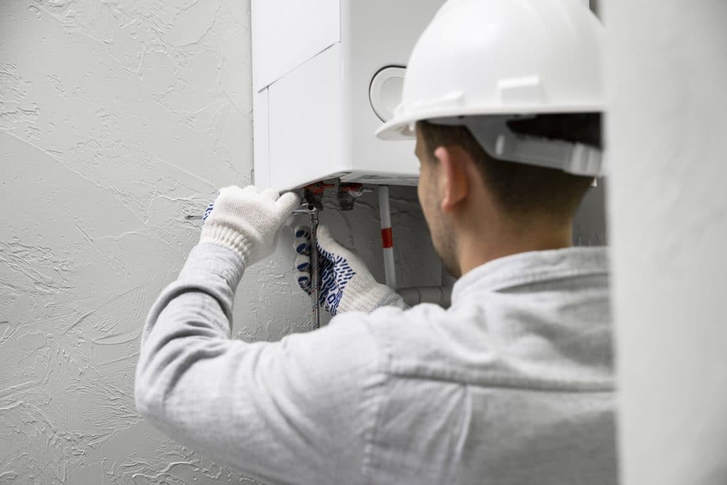 plumber fixing water heater