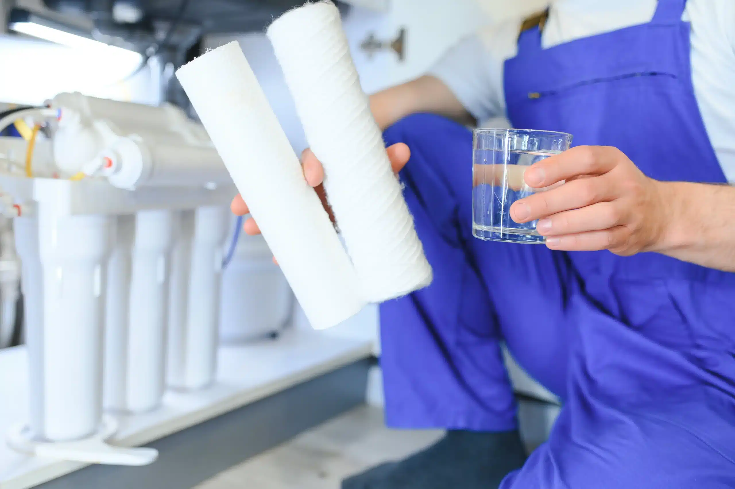 Plumber installs or change water filter replacement 